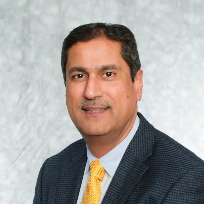 a man in a suit and tie posing for a picture